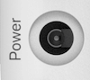 A rectangular recess with a small round socket at one end. The power supply cable plugs into it.